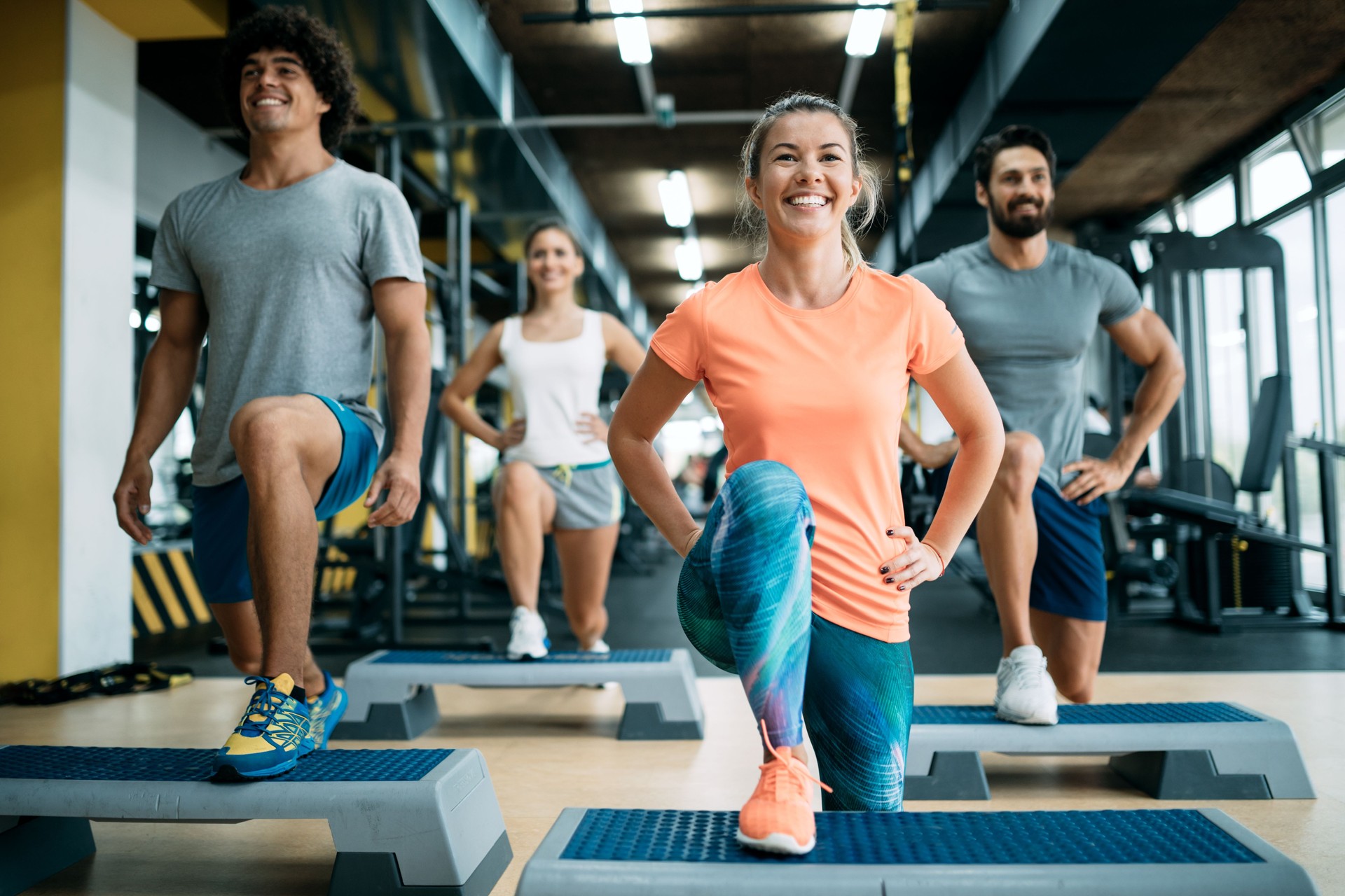 Group of young people doing exercises in gym